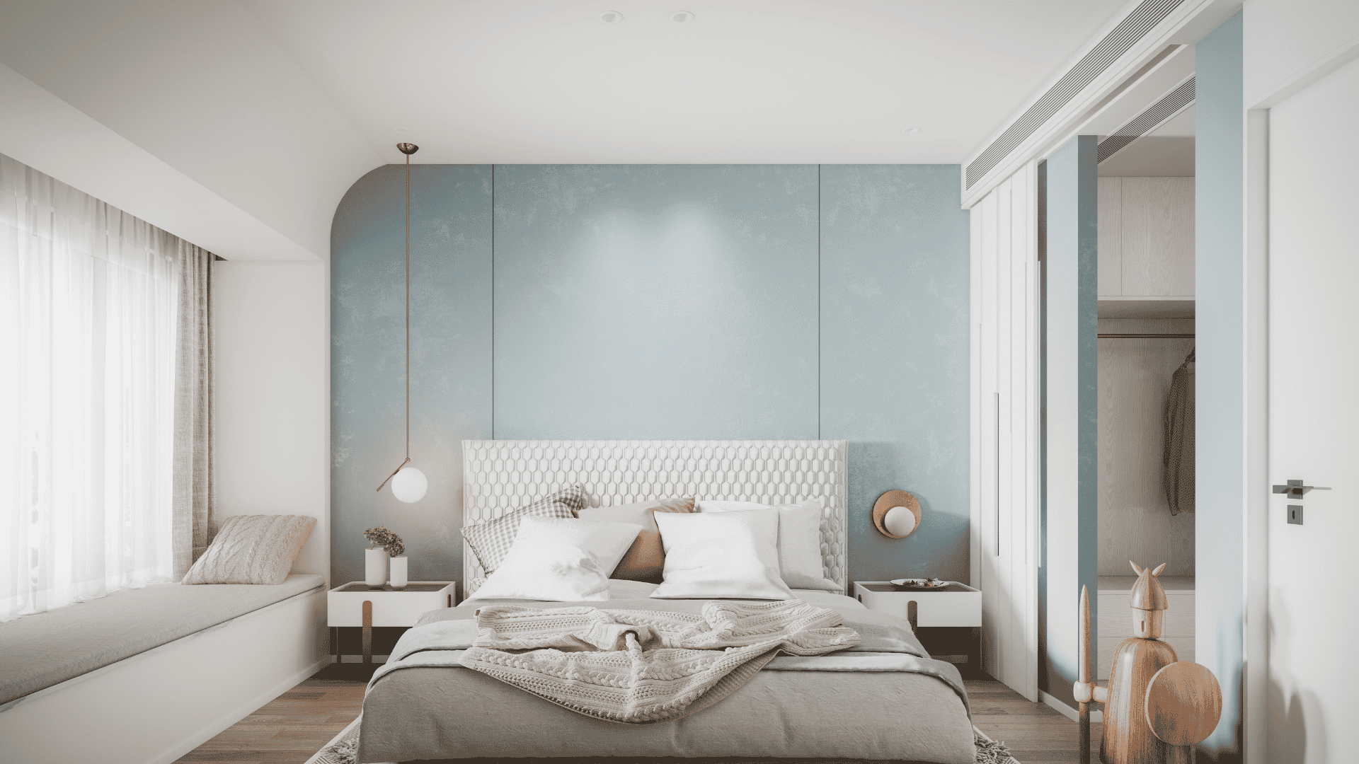 Modern blue bedroom interior featuring a light blue accent wall and a cozy bed with throw pillows