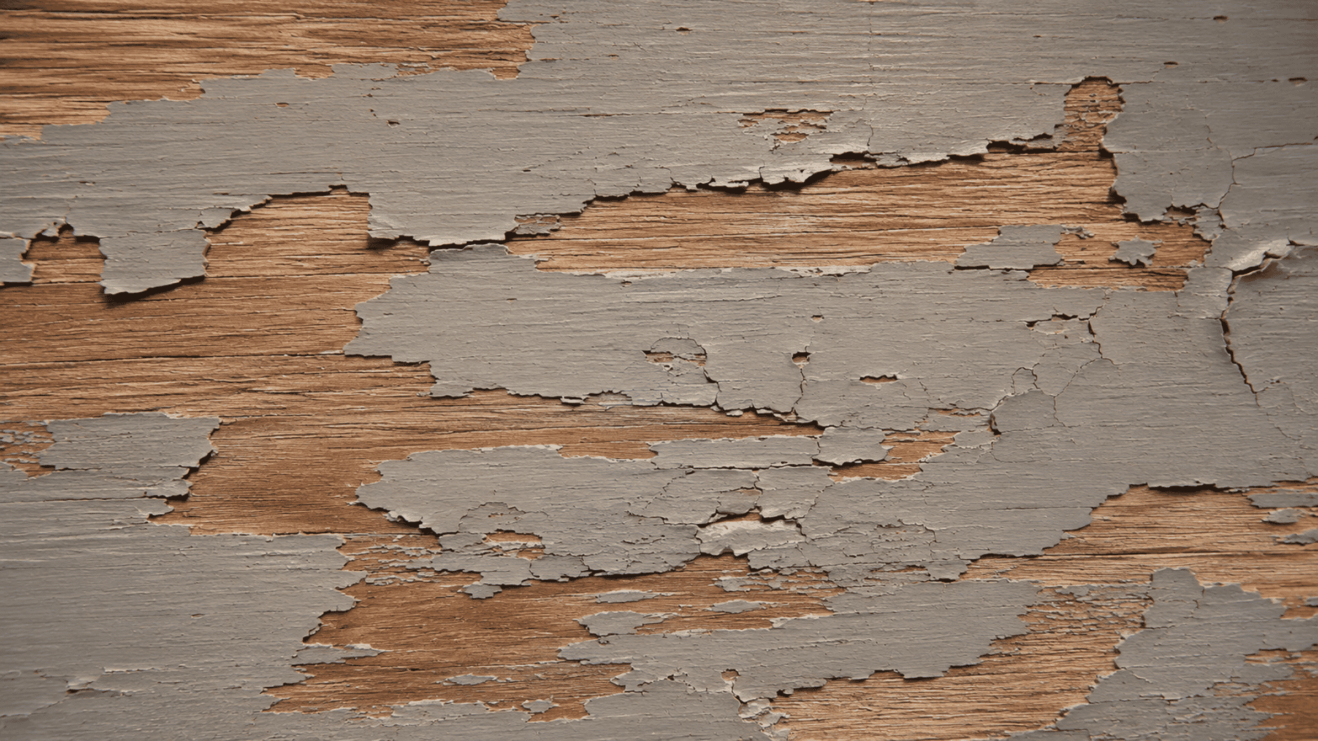 patchy and cracked acrylic paint finish on a wooden board.