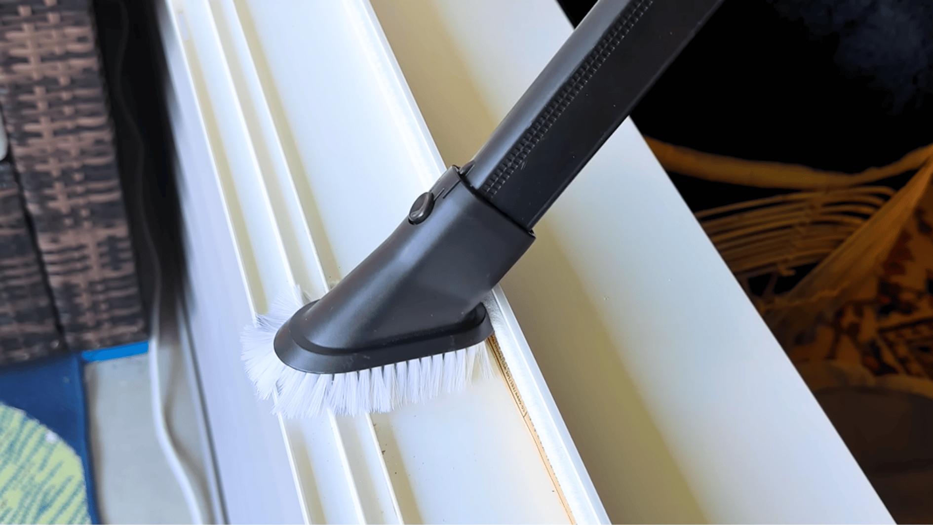 small cleaning brush scrubbing dirt and buildup from a window track