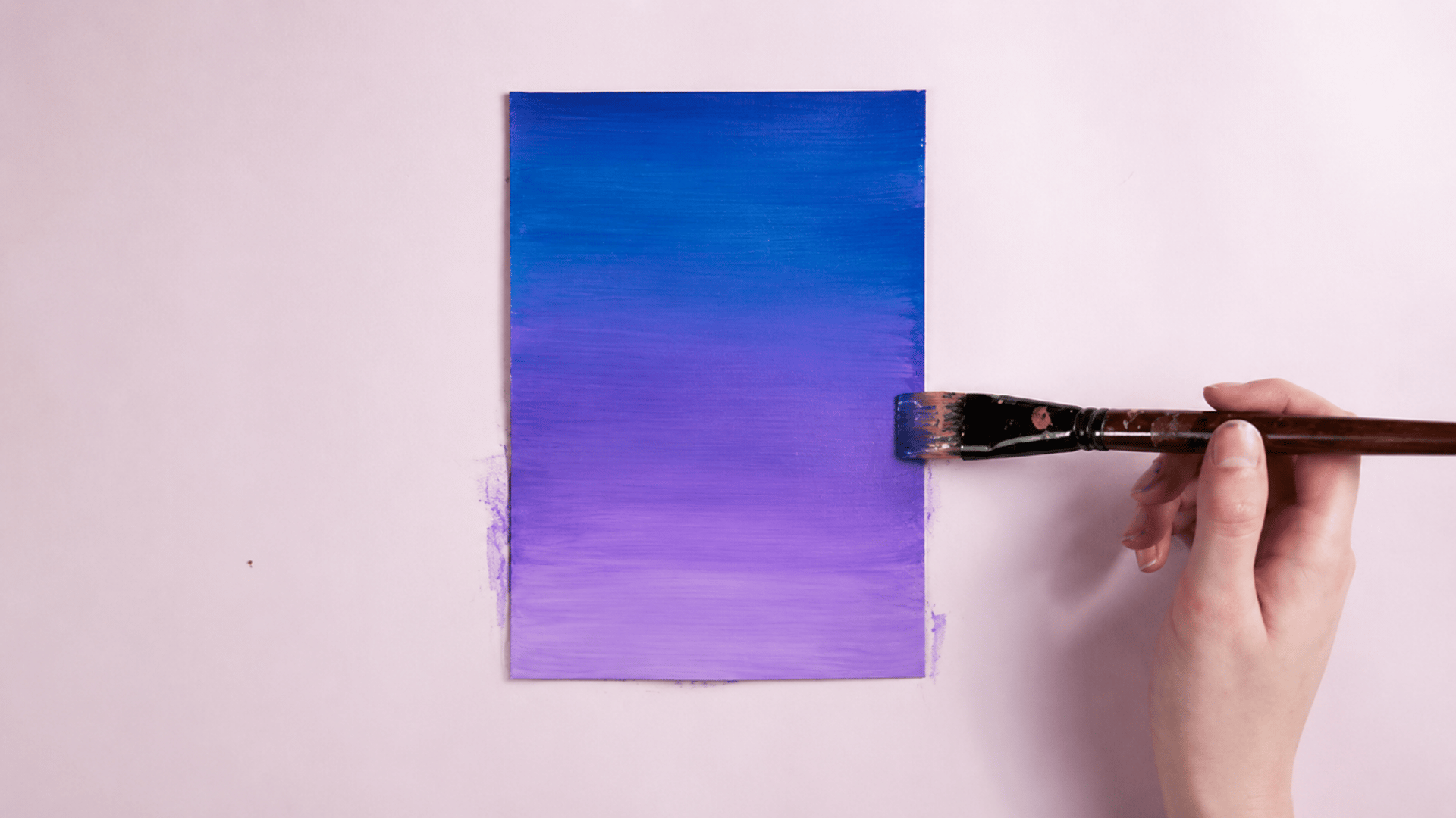smoothly blended acrylic paint colors creating a gradient effect on a wooden surface
