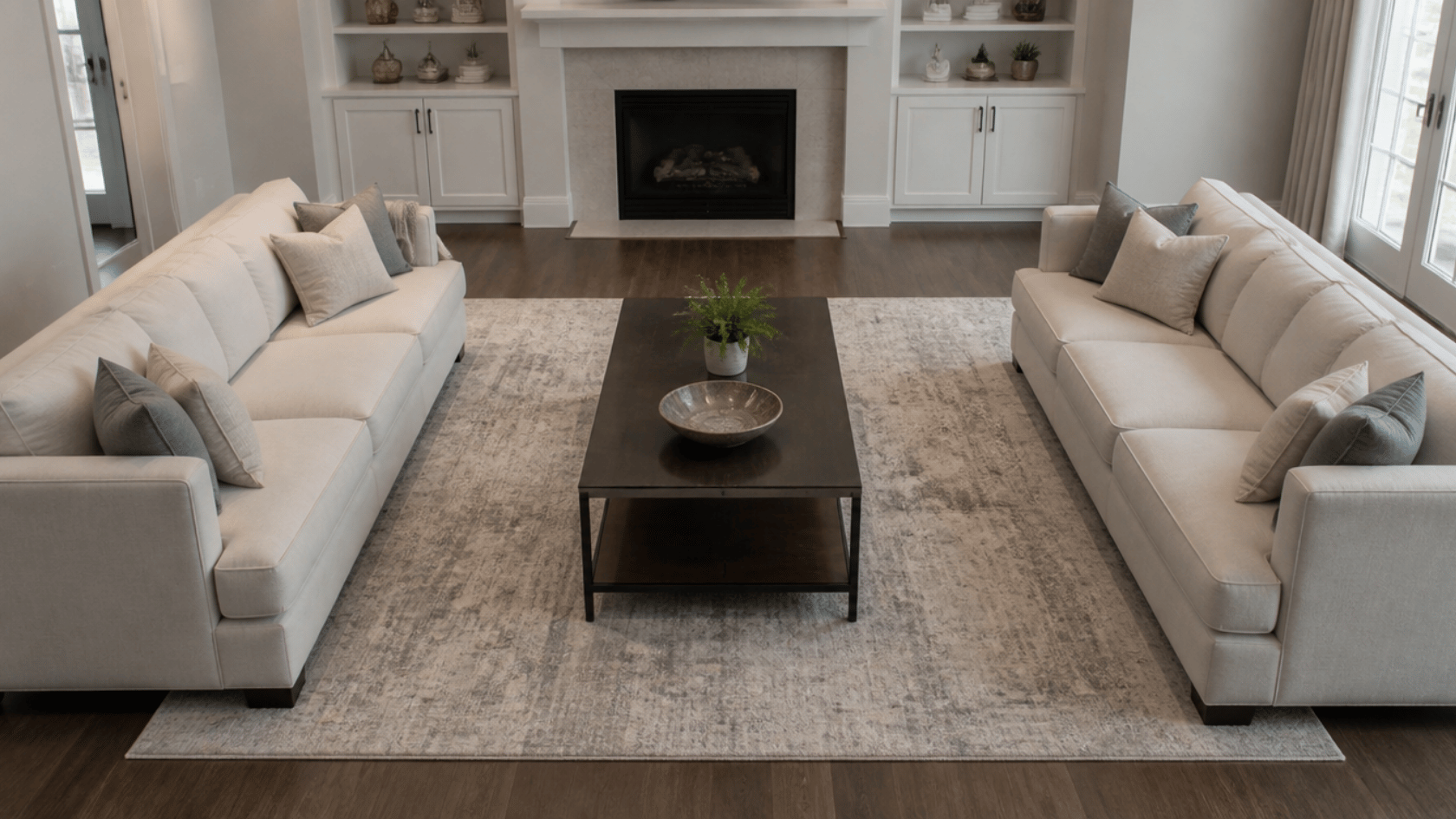 Two sofas facing each other with a coffee table in the middle on a rug