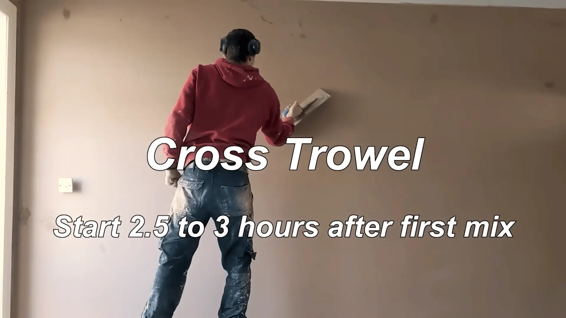 Using a cross trowel technique 2.5 to 3 hours after the first mix, applying firm pressure to smooth and polish the plastered wall