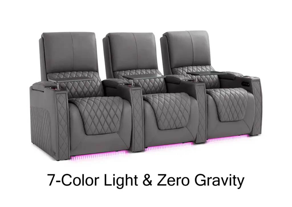 Three gray recliner chairs with quilted pattern and cup holders, under soft pink LED lighting