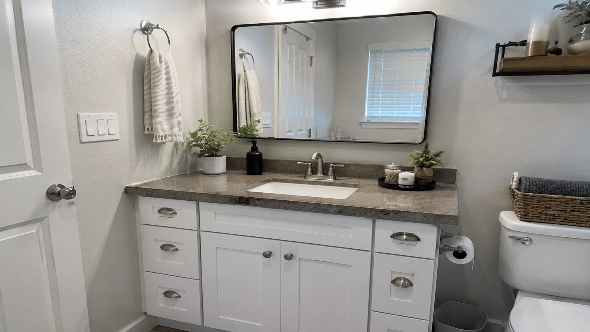 a repurposed kitchen cabinet styled to bathroom vanity diy style finish with neutral theme and mirror with bathroom decor