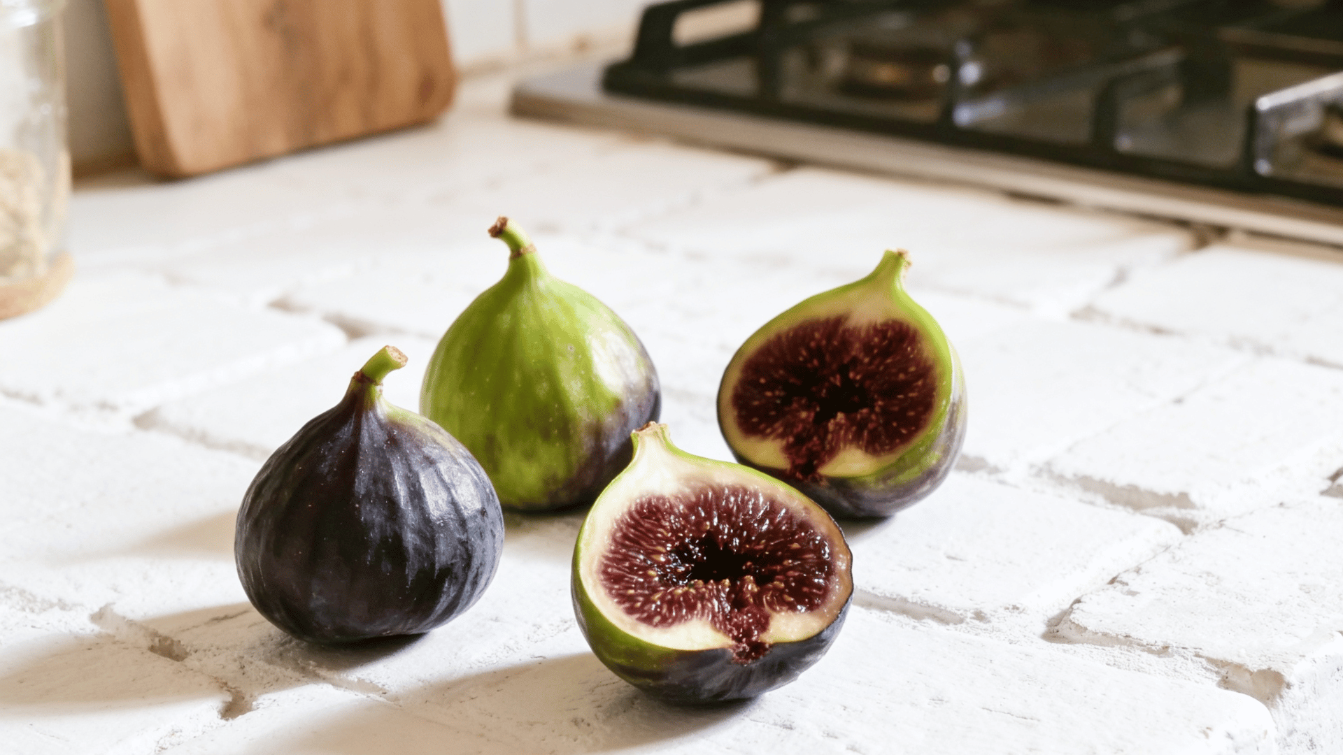 alma figs green thick skin sliced showing dense juicy interior warm rustic kitchen ligh