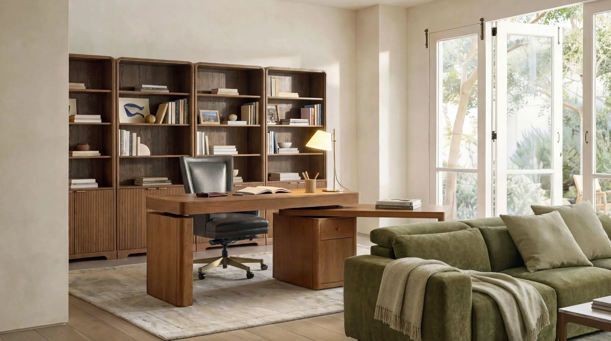 Modern home office with brown desk, bookshelves, and green sofa under natural light