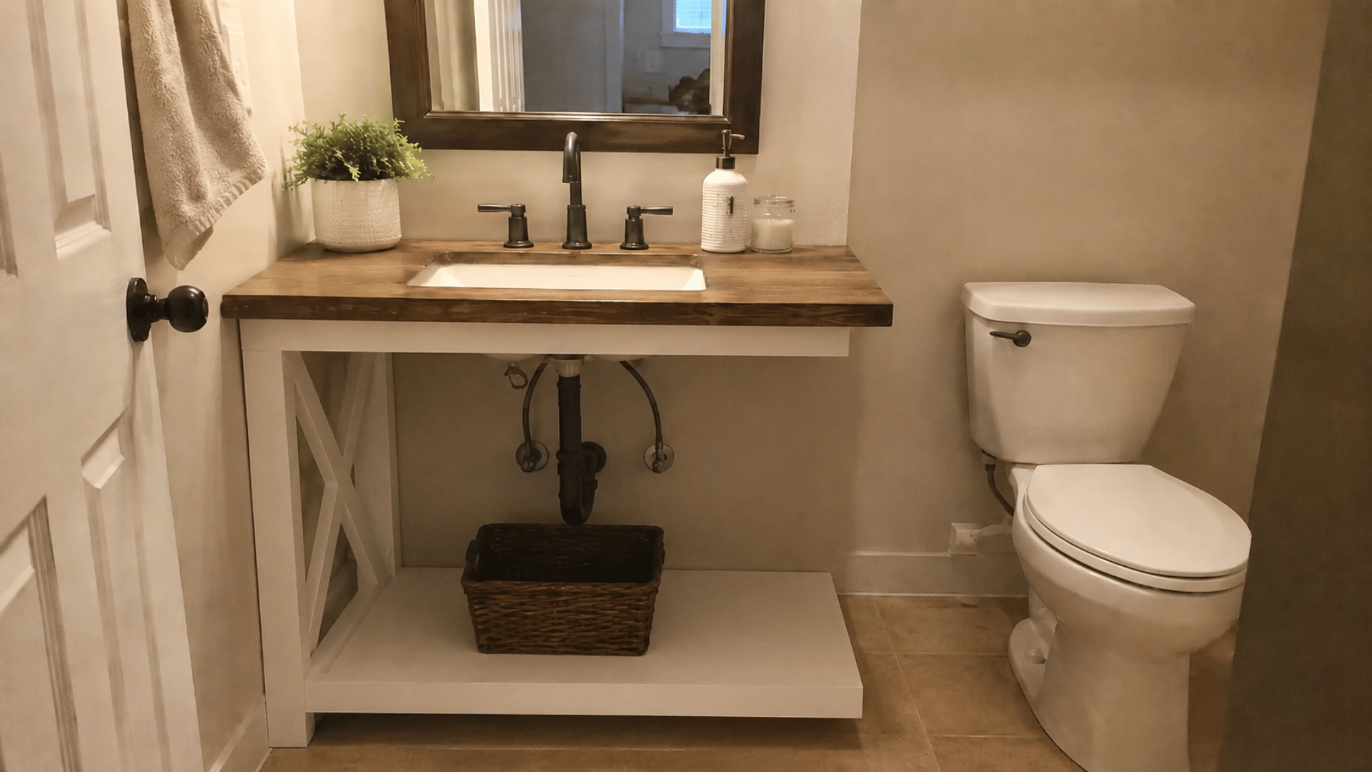 cozy neutral toned bathroom interior with x brace table repurposed as bathroom vanity neutral indoor lighting and table secured in wall