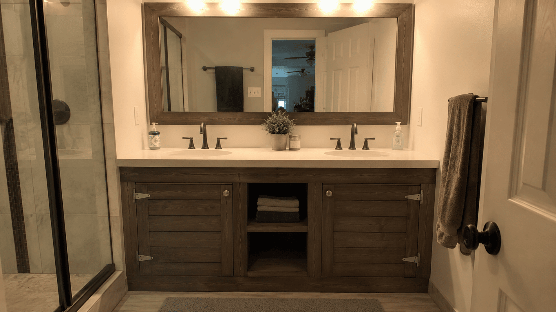 diy build shiplap wrapped based bathroom vanity in a spacious bathroom design with diy style finish and mirror installed farmhouse style theme