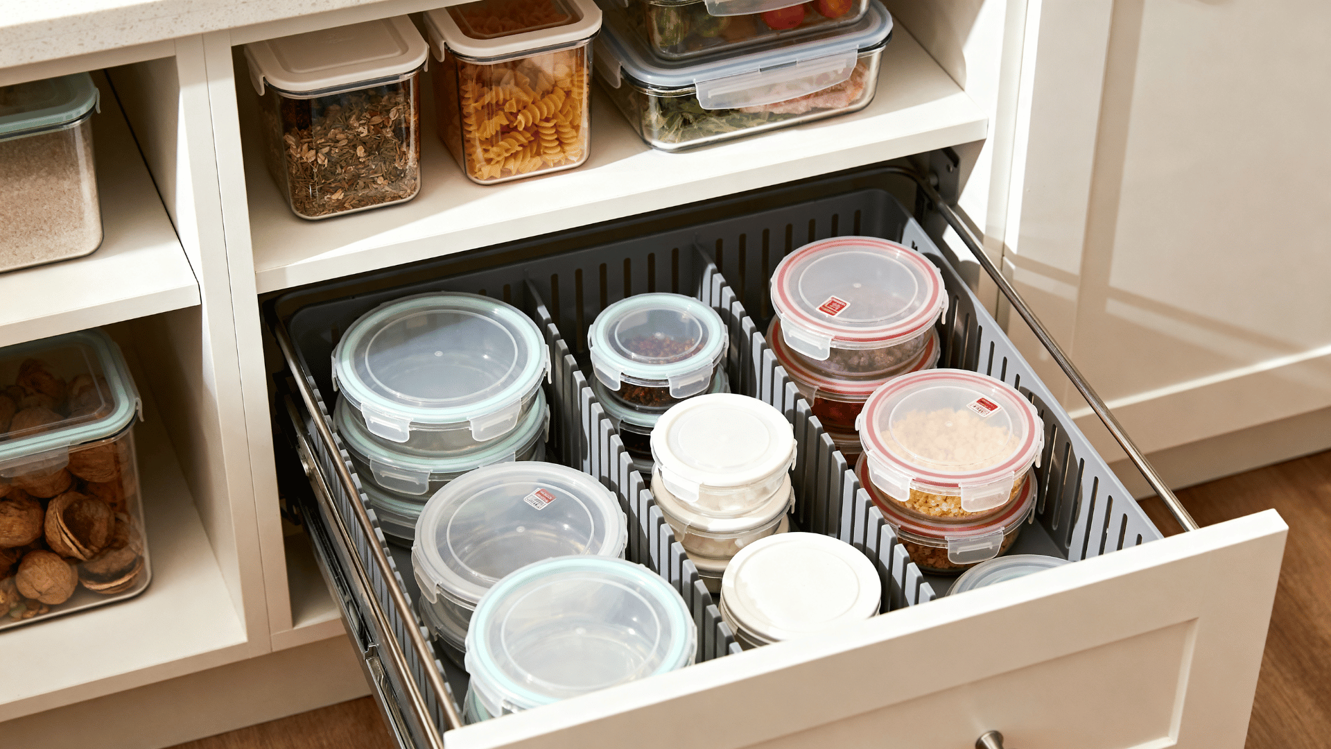 kitchen drawer with container lids stored vertically using dividers to maintain a neat organized storage system (1)