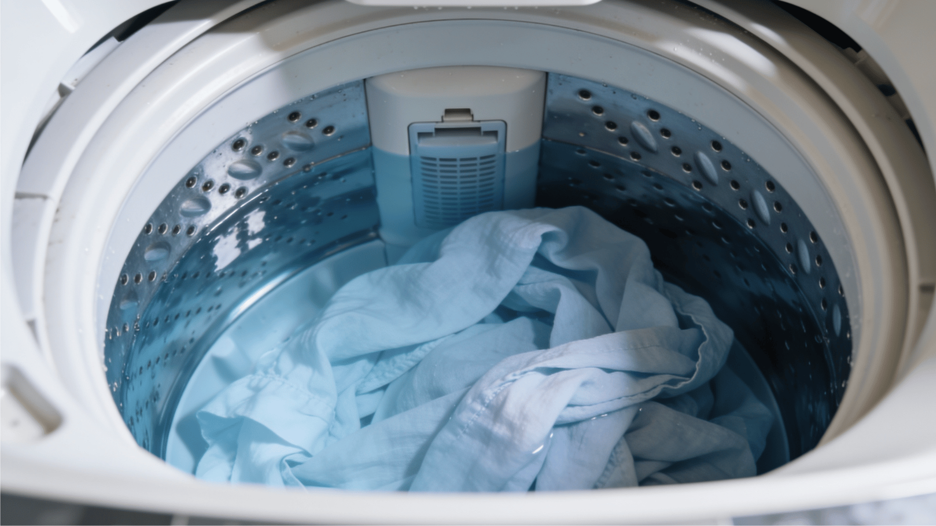 light colored linen garments being gently washed in cold water in a washing machine