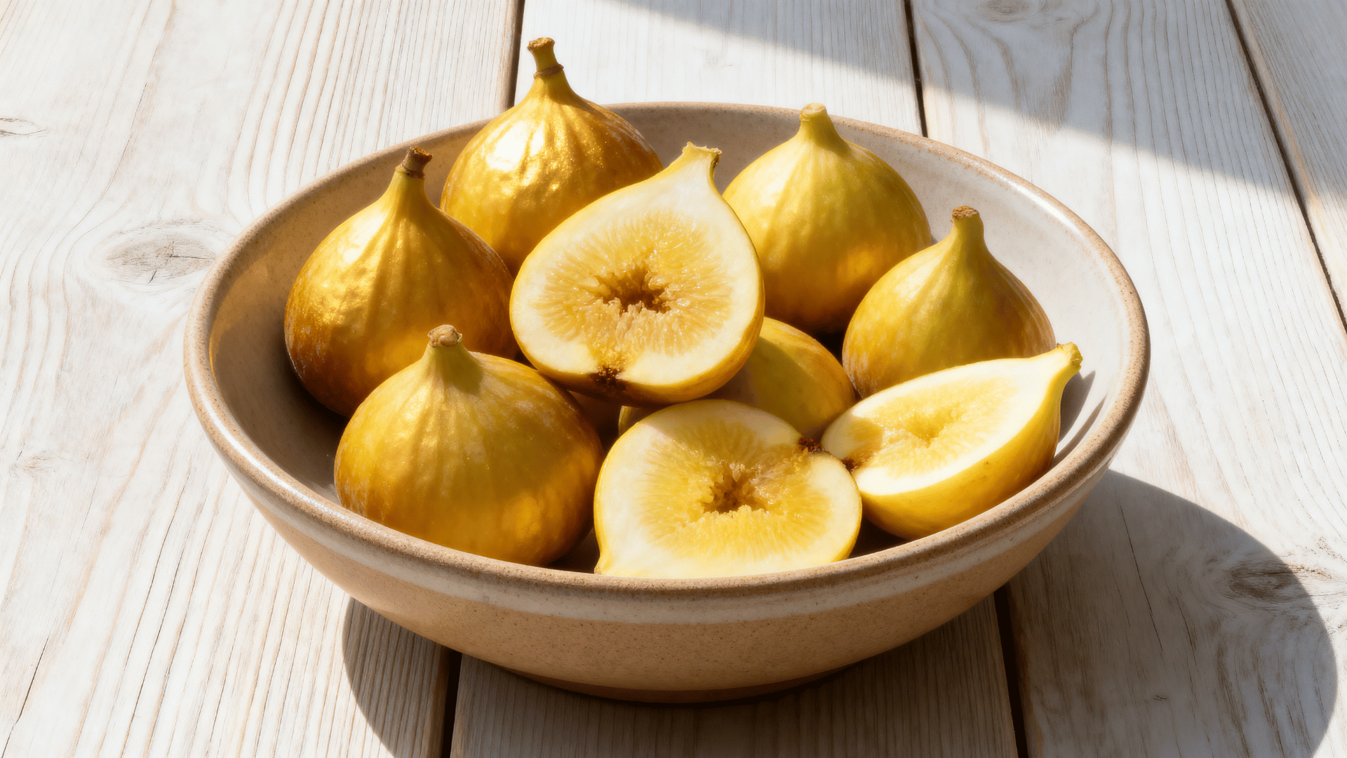 lsu gold figs yellow skin in bowl sliced showing soft interior bright natural light