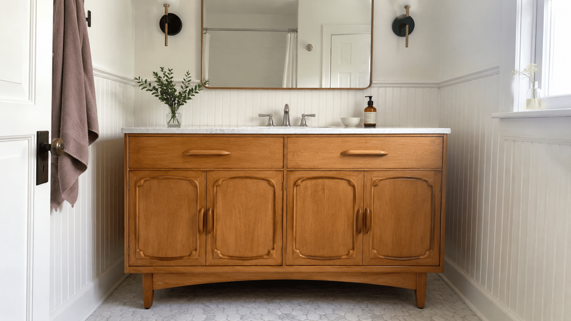 mid century credenza bathroom vanity in a small home bathroom setting natural light and white bathroom background