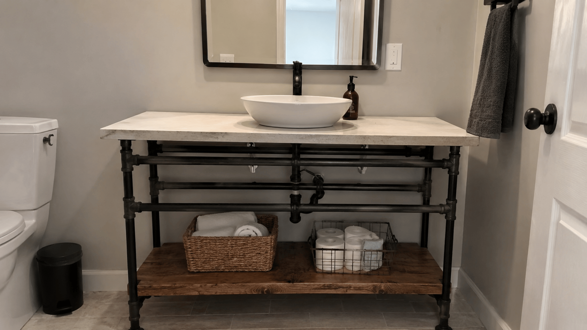 modern industrial pipe based bathroom vanity with rustic touches in a simple bathroom setup mirror and white bathroom design