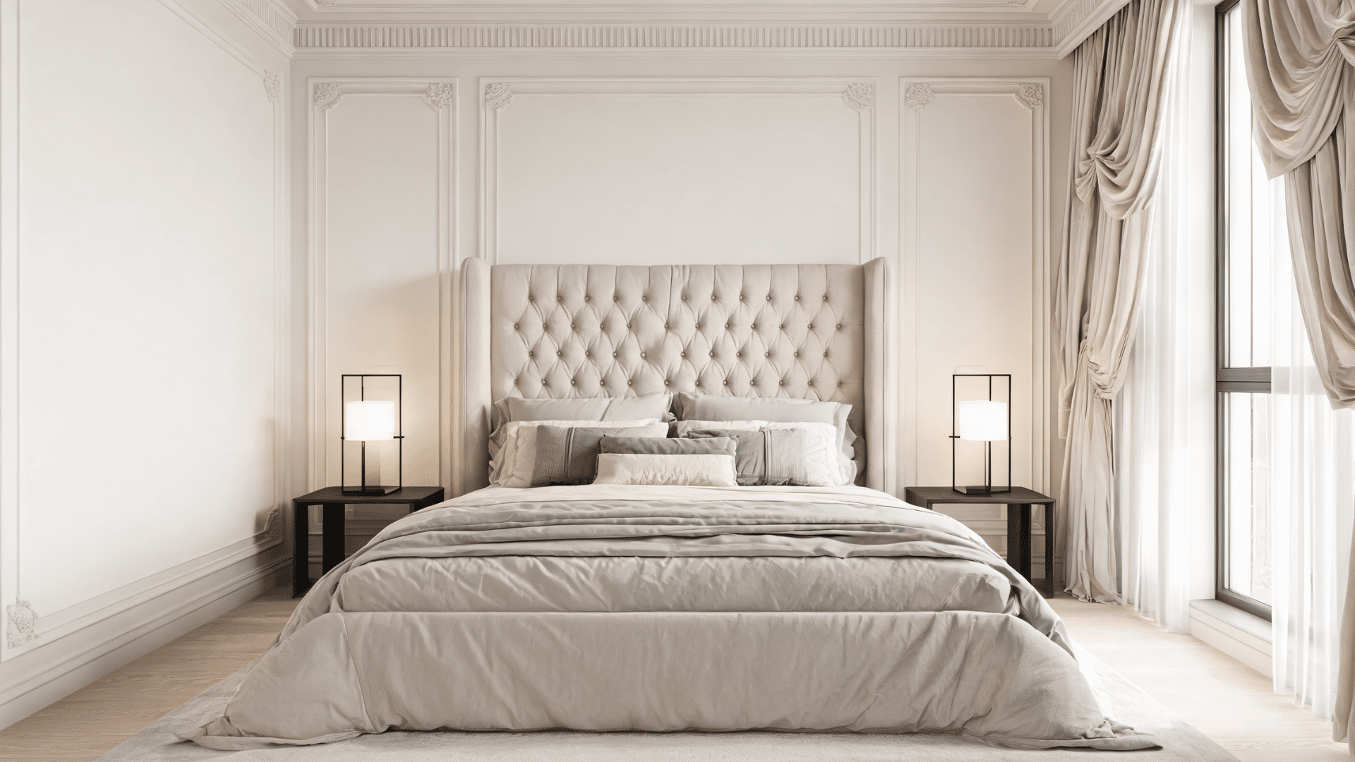 Bedroom with tufted headboard, layered bedding, curtains, lamps, and wall molding in modern Victorian style