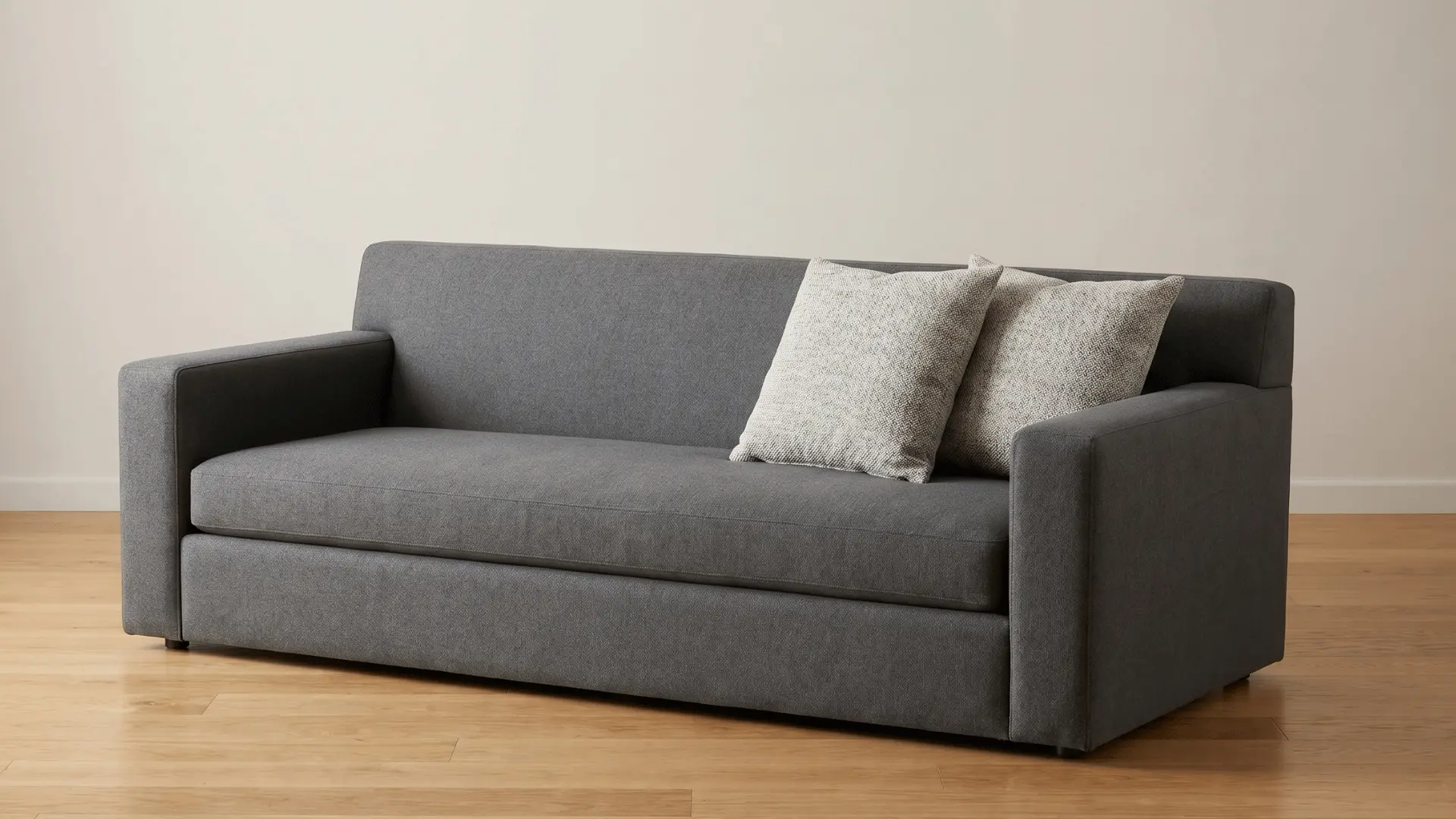 Sofa with straight arms, tight backrest, and loose cushions placed on the seat