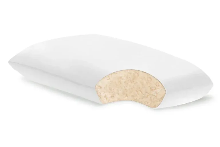 White memory foam pillow with a cutaway revealing soft filling in a studio setting