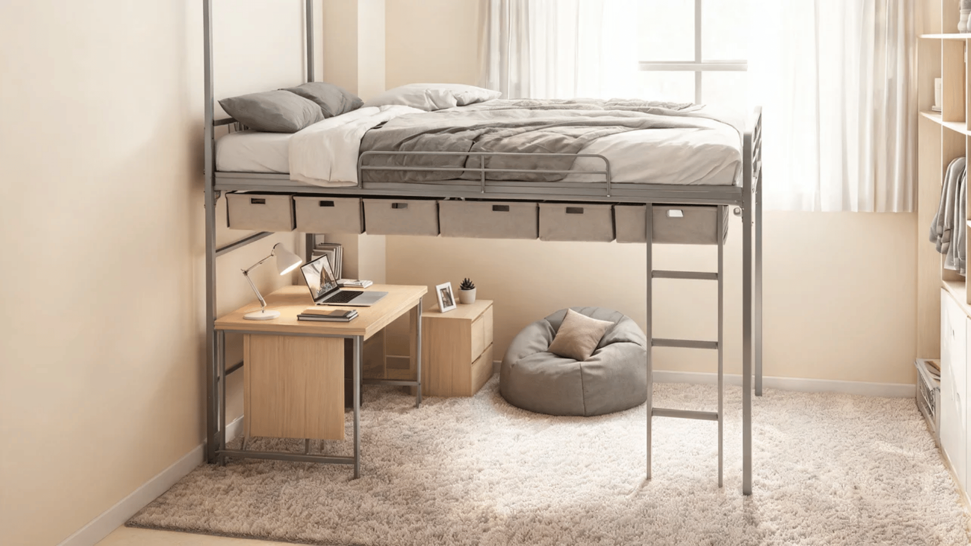 Lofted dorm bed with storage underneath, under-bed bins, and a plush rug in a small room.