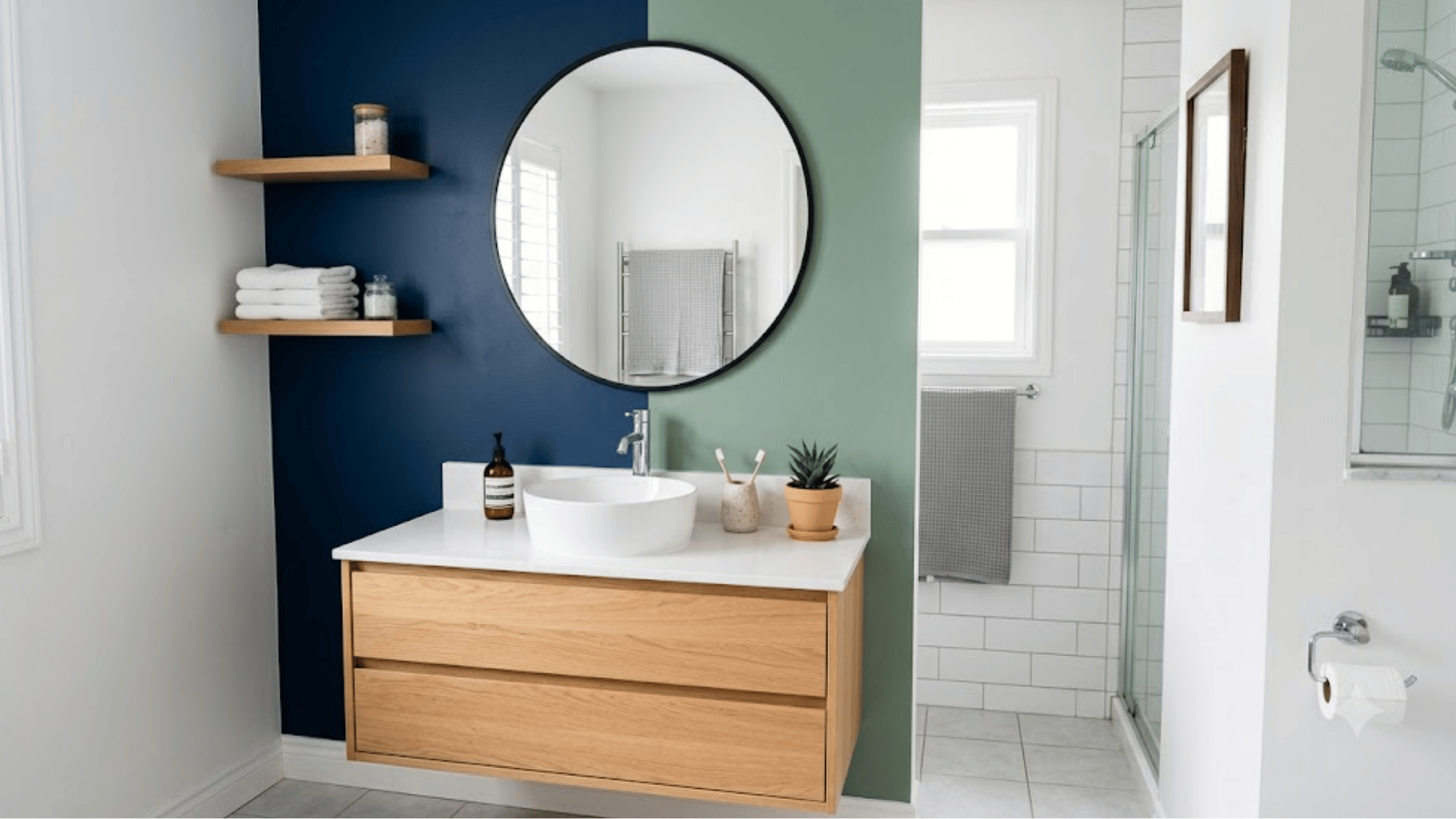 bathroom with color blocked painted accent wall behind mirror