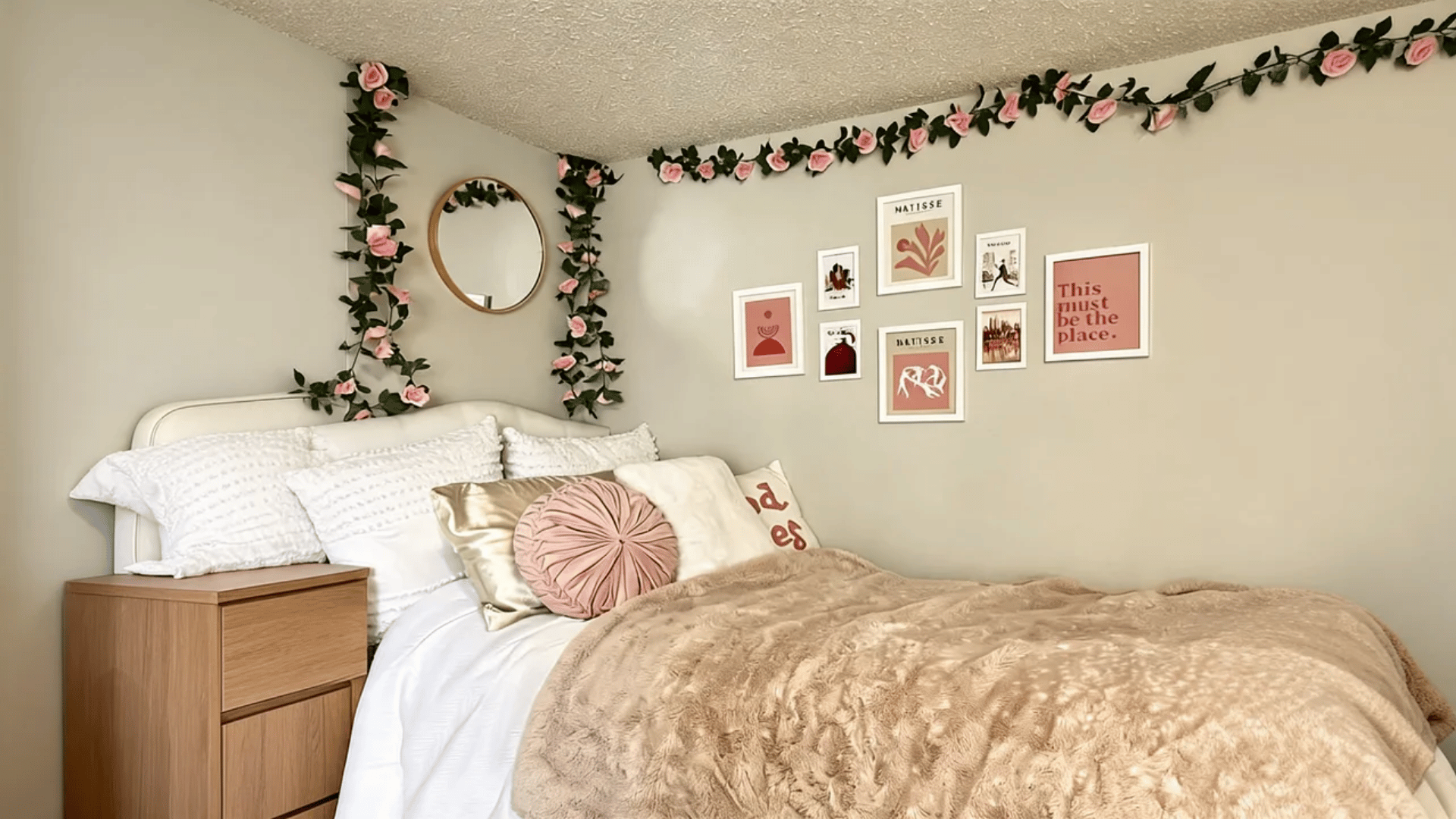 Dorm bed with plush novelty pillows and soft textured throw blankets in a cozy setup.