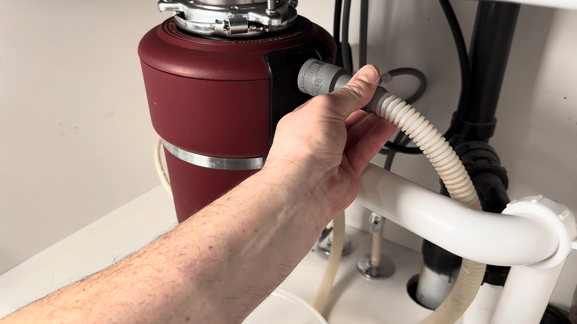 Checking the dishwasher drain hose and garbage disposal connection for clogs