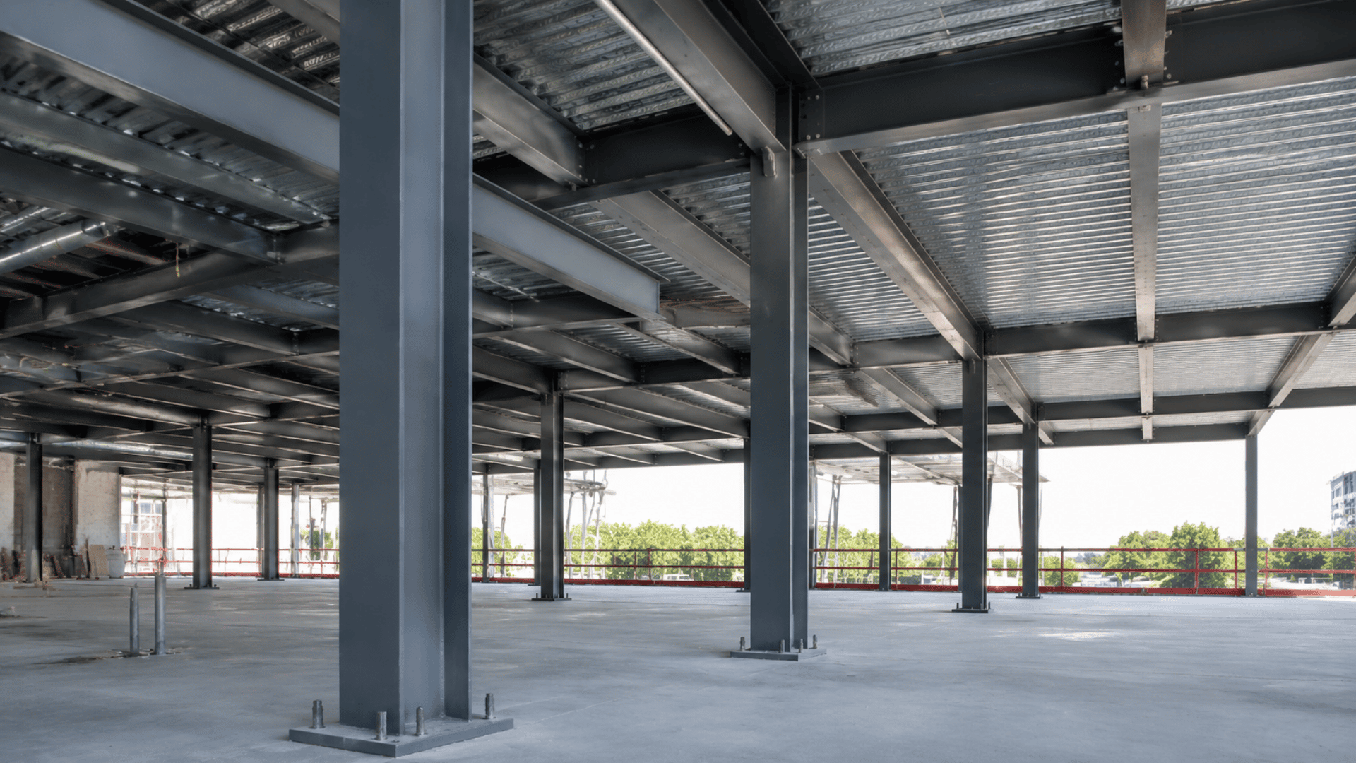 Exposed steel structural columns inside a modern commercial building under construction