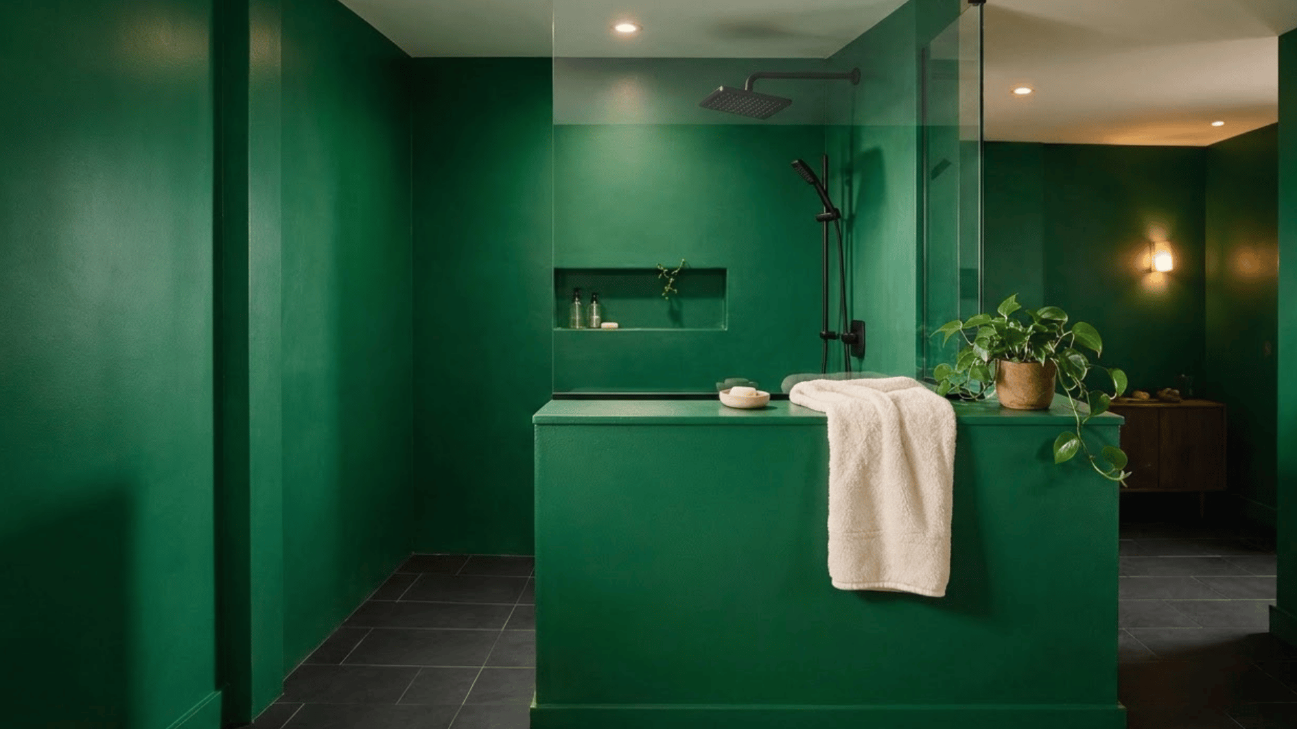 green colour drenched pony wall shower with black fixtures, recessed niche, and modern open bathroom design (1)