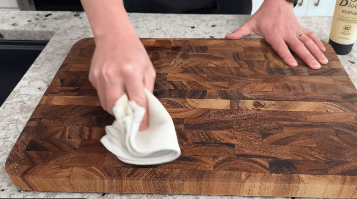 hand applying food safe beeswax with cloth on wooden board  (2)