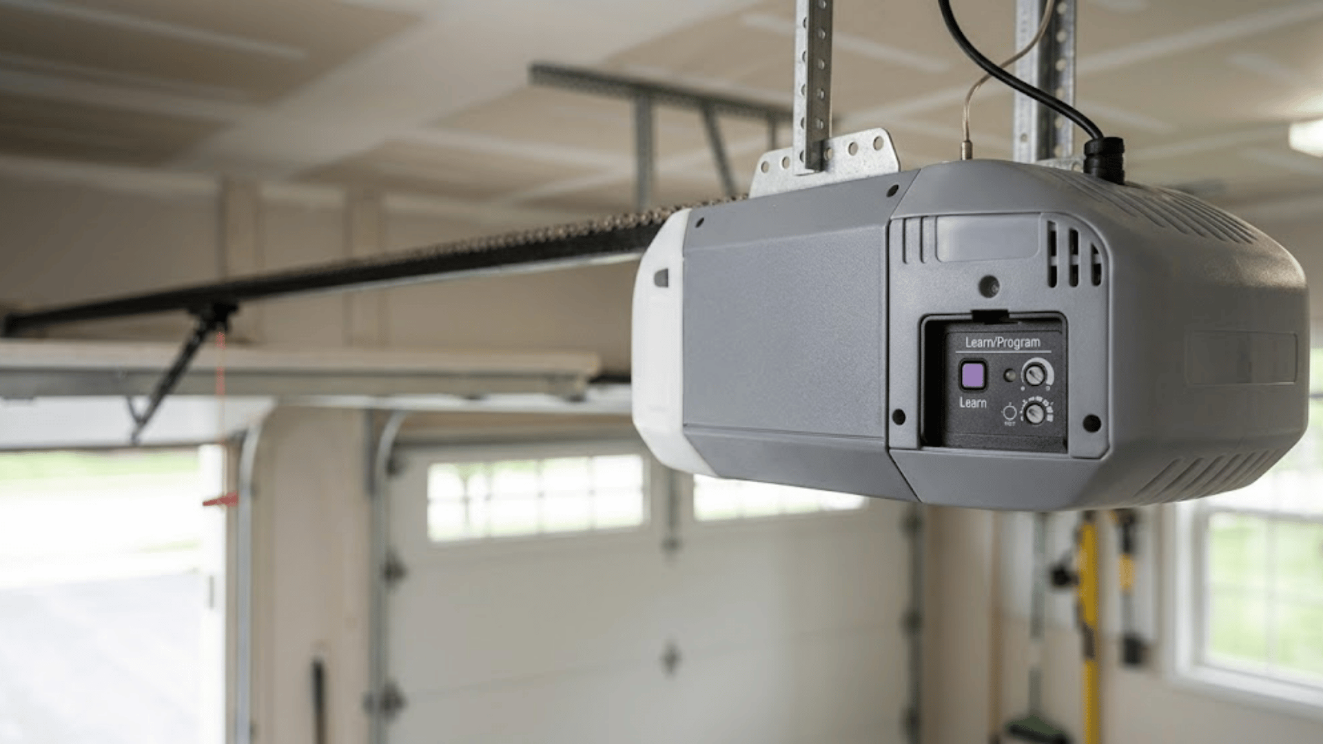 How to program a garage door opener by locating the Learn button on the motor unit panel