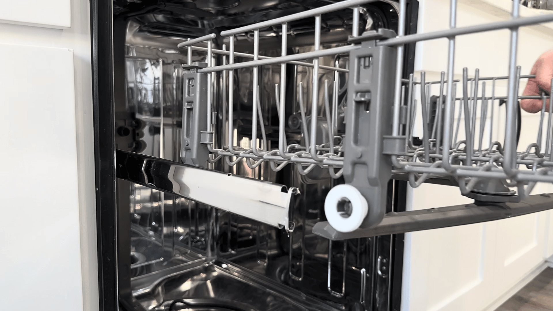 Inspecting the dishwasher drain area and spray components for blockages