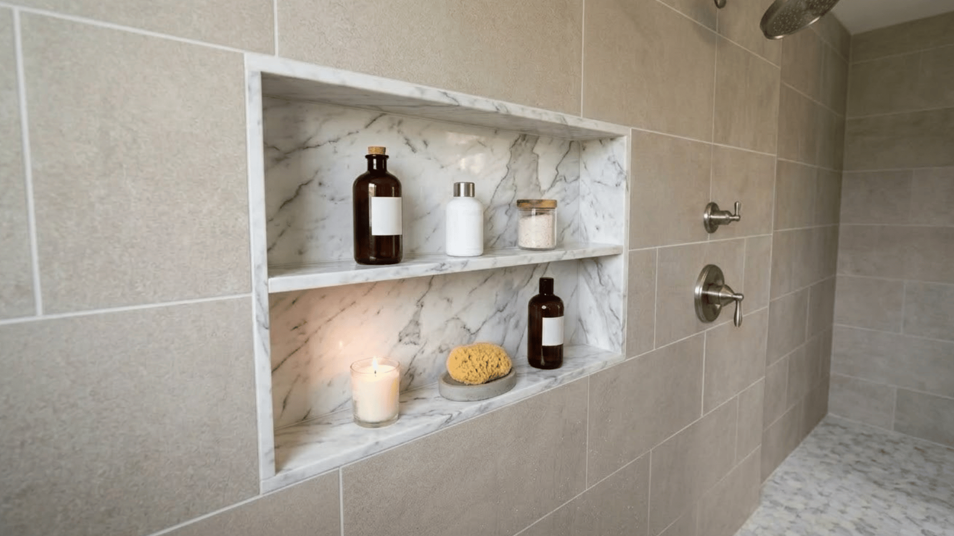 marble tile shower niche with toiletries and candles inside a modern open tiled shower wall