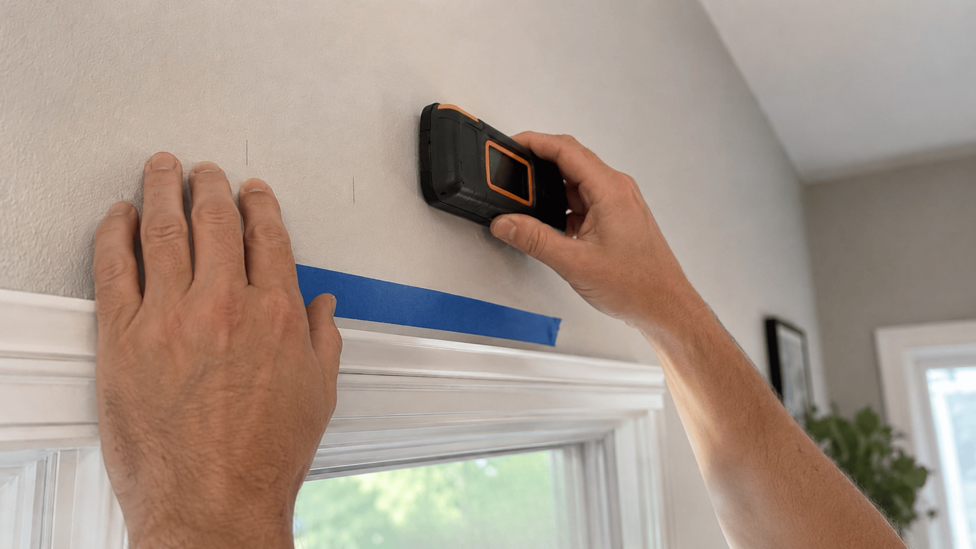 marking wall with stud finder before drilling curtain rod bracket holes (1)