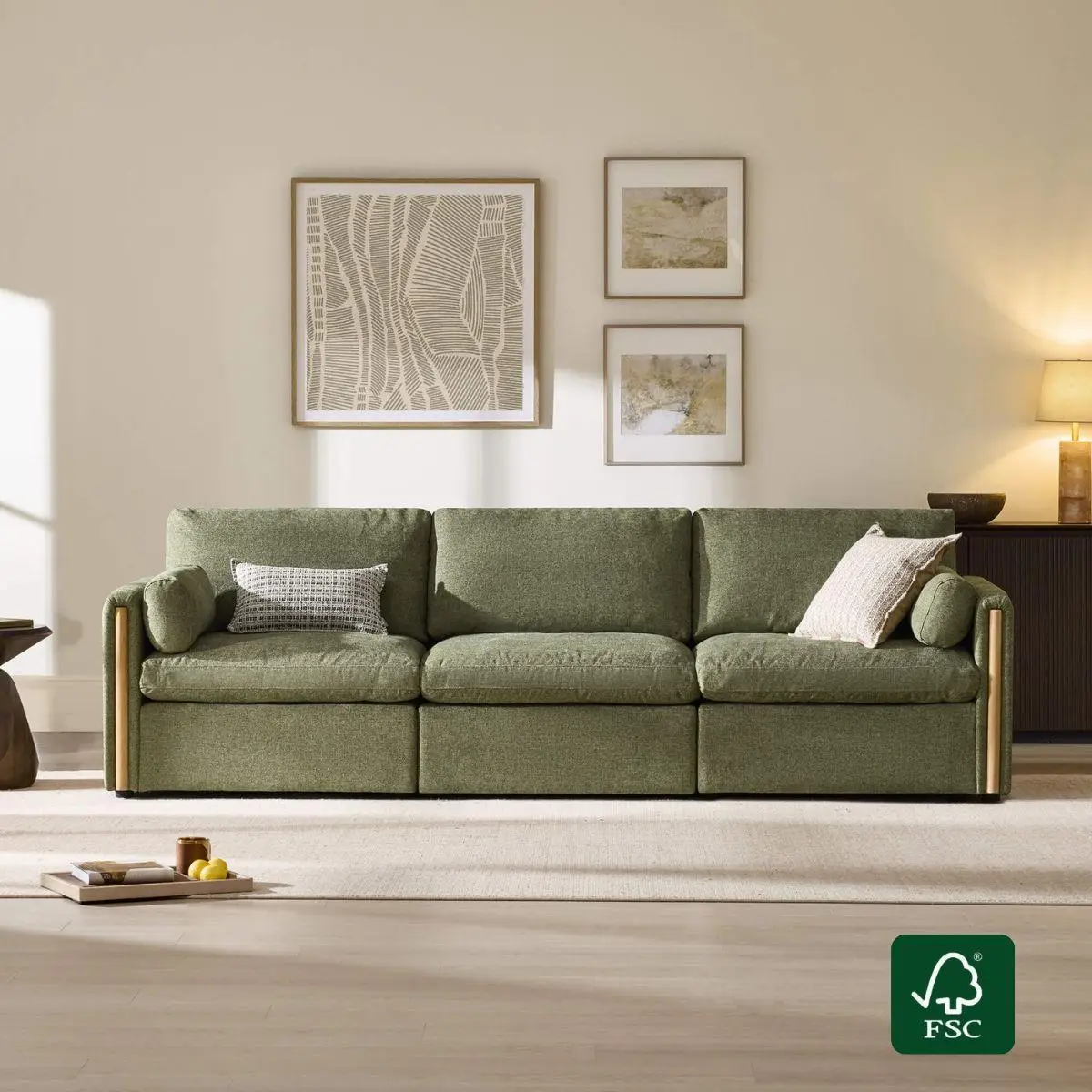 Green sofa in living room with white walls and framed abstract art above
