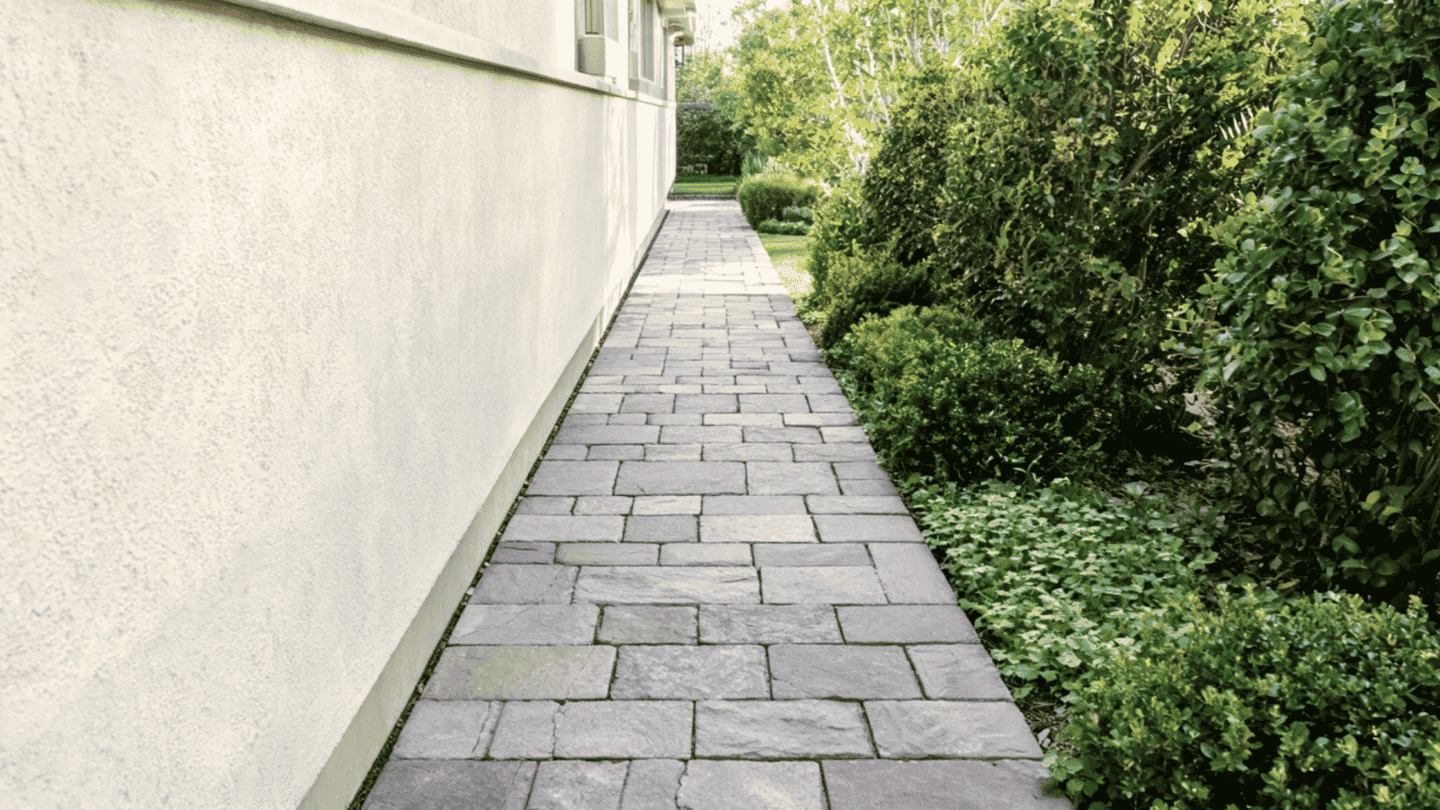 Narrow side yard stone walkway connecting the front and backyard areas