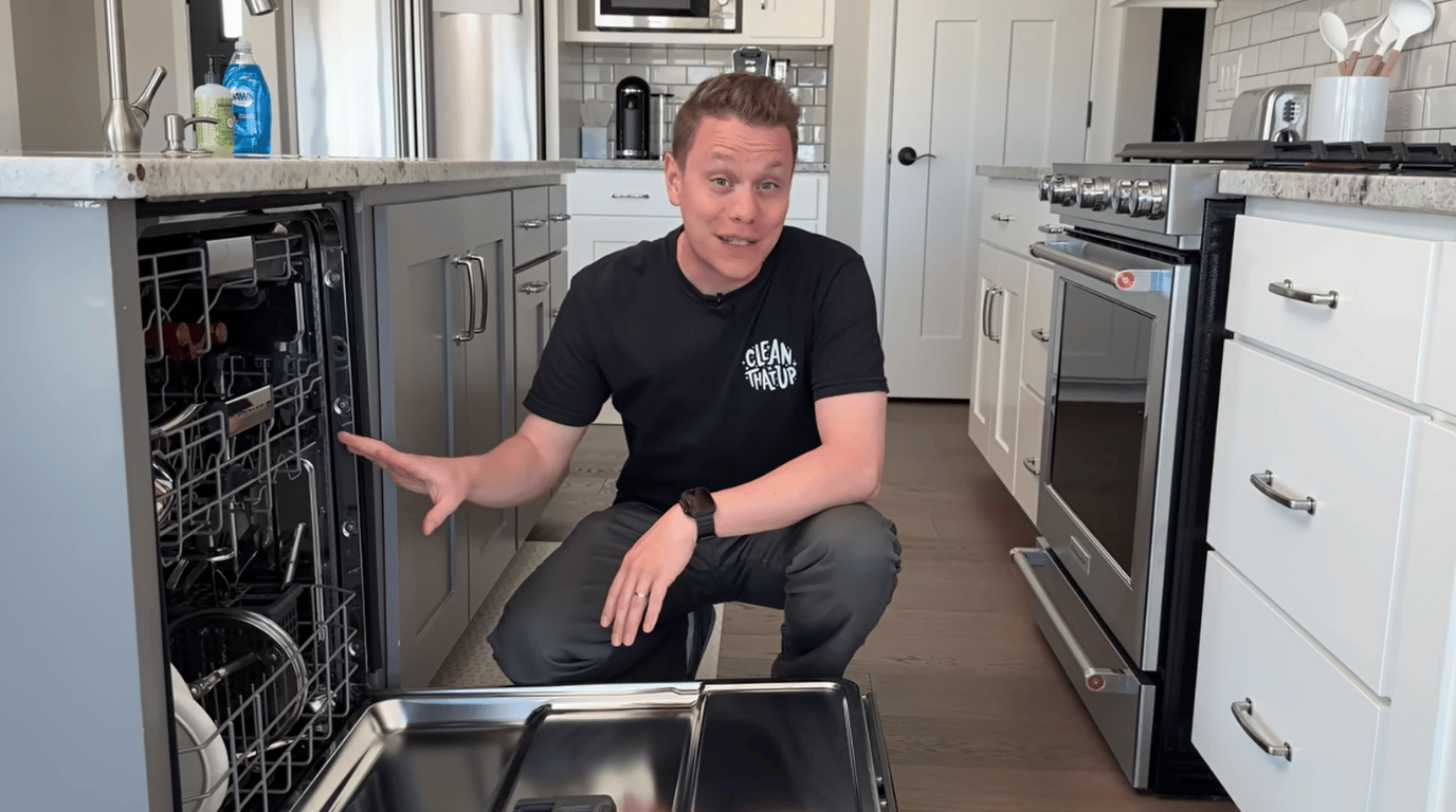 person opening a dishwasher beside a wooden cutting board to show cleaning method comparison