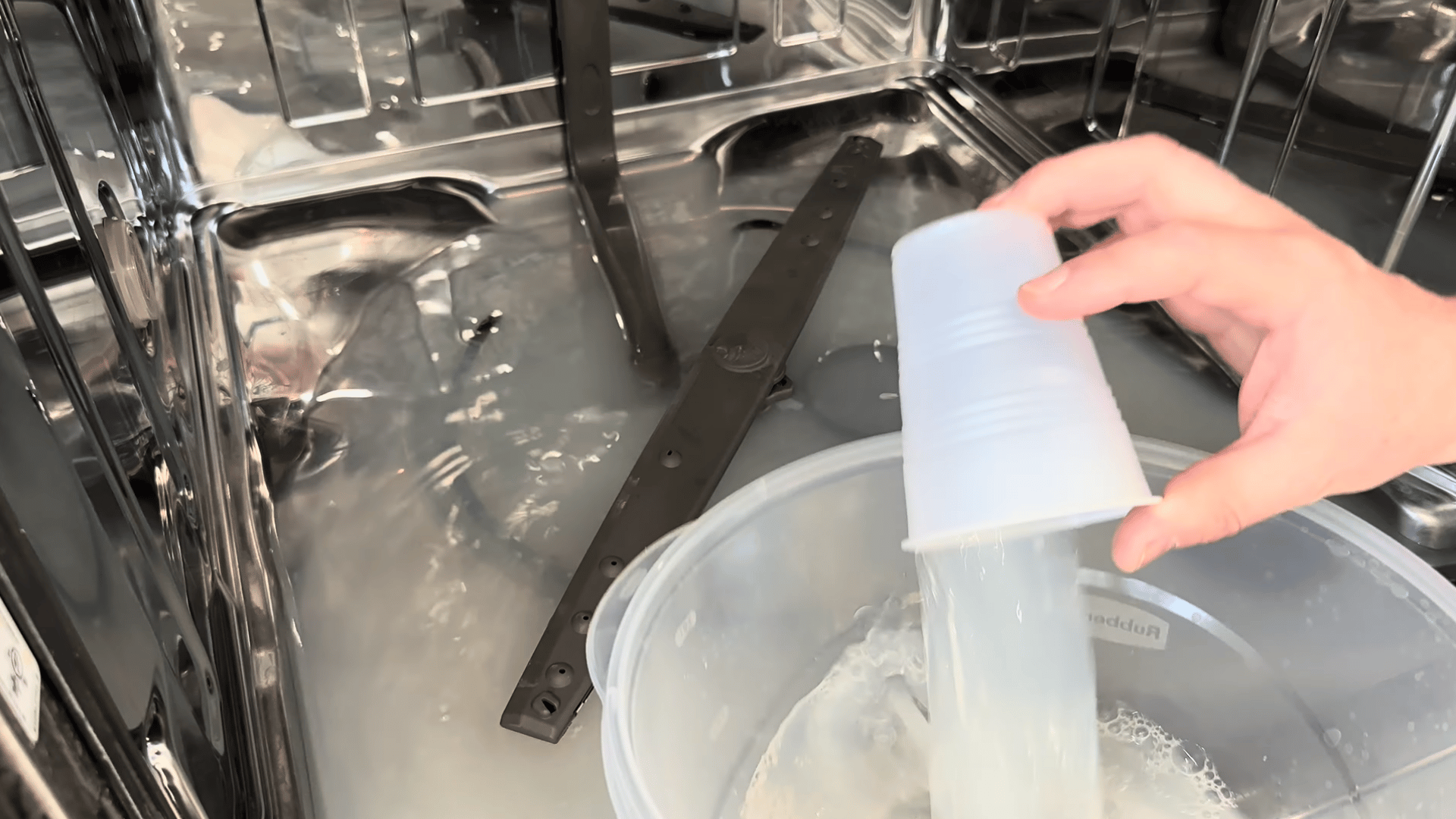 Removing standing water and cleaning the dishwasher filter to fix drainage issues