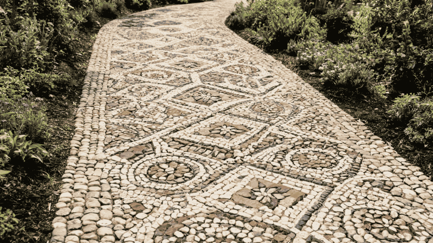 Stone walkway ideas showcasing a decorative pebble mosaic pathway with floral patterns