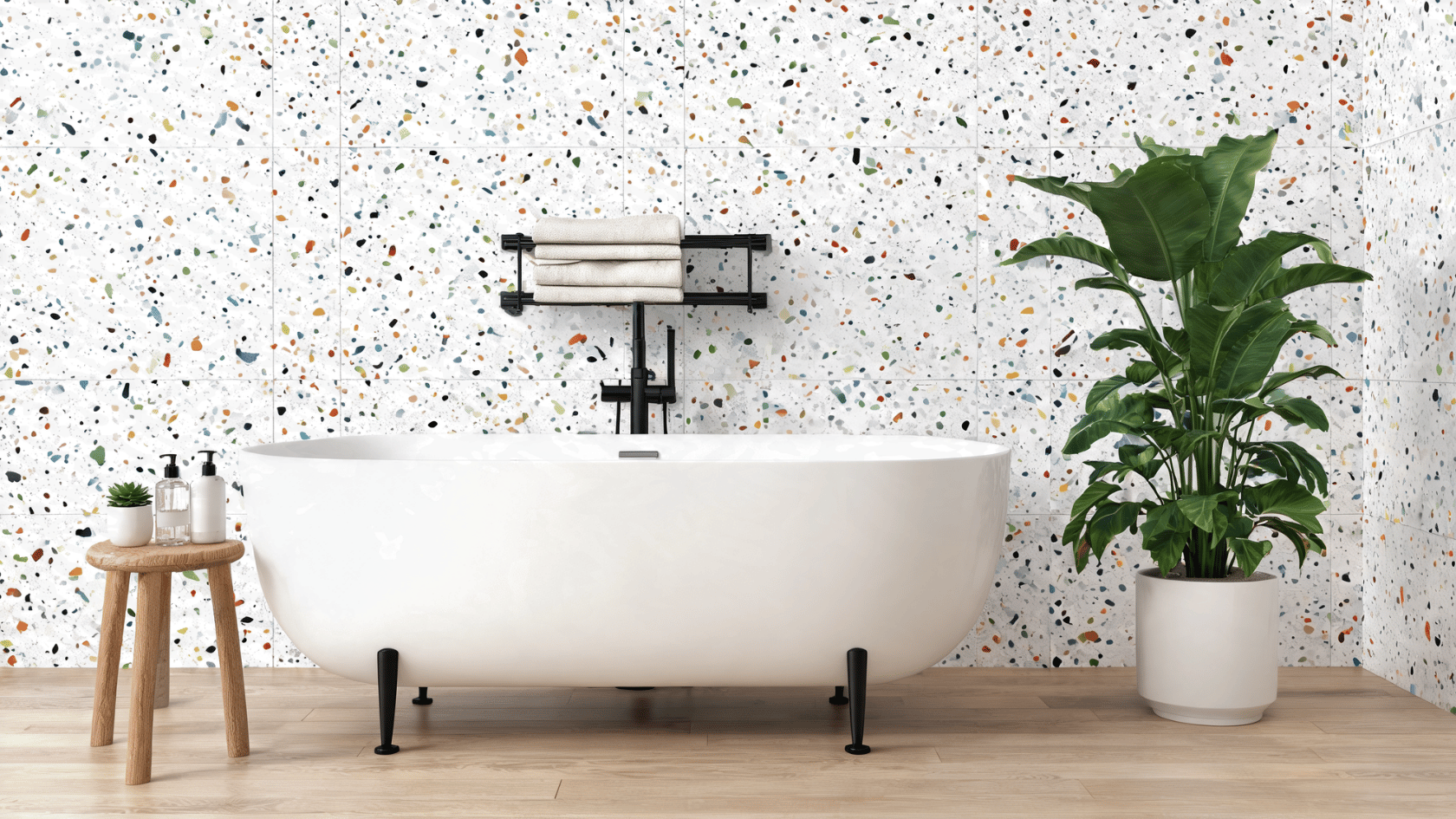 Terrazzo wall panels with freestanding bathtub, wooden stool, towel rack, and indoor plant in a bathroom.