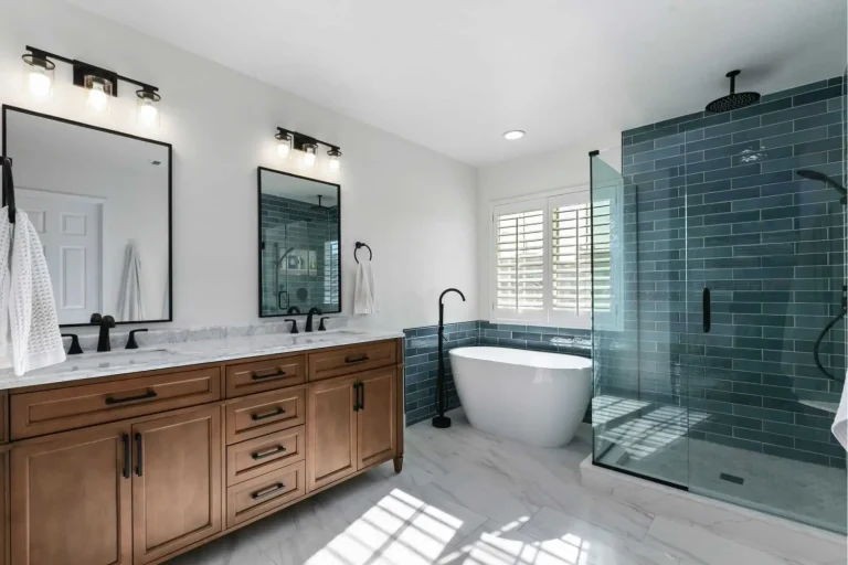 Modern bathroom with freestanding tub, glass shower enclosure, and wooden vanity under bright lighting