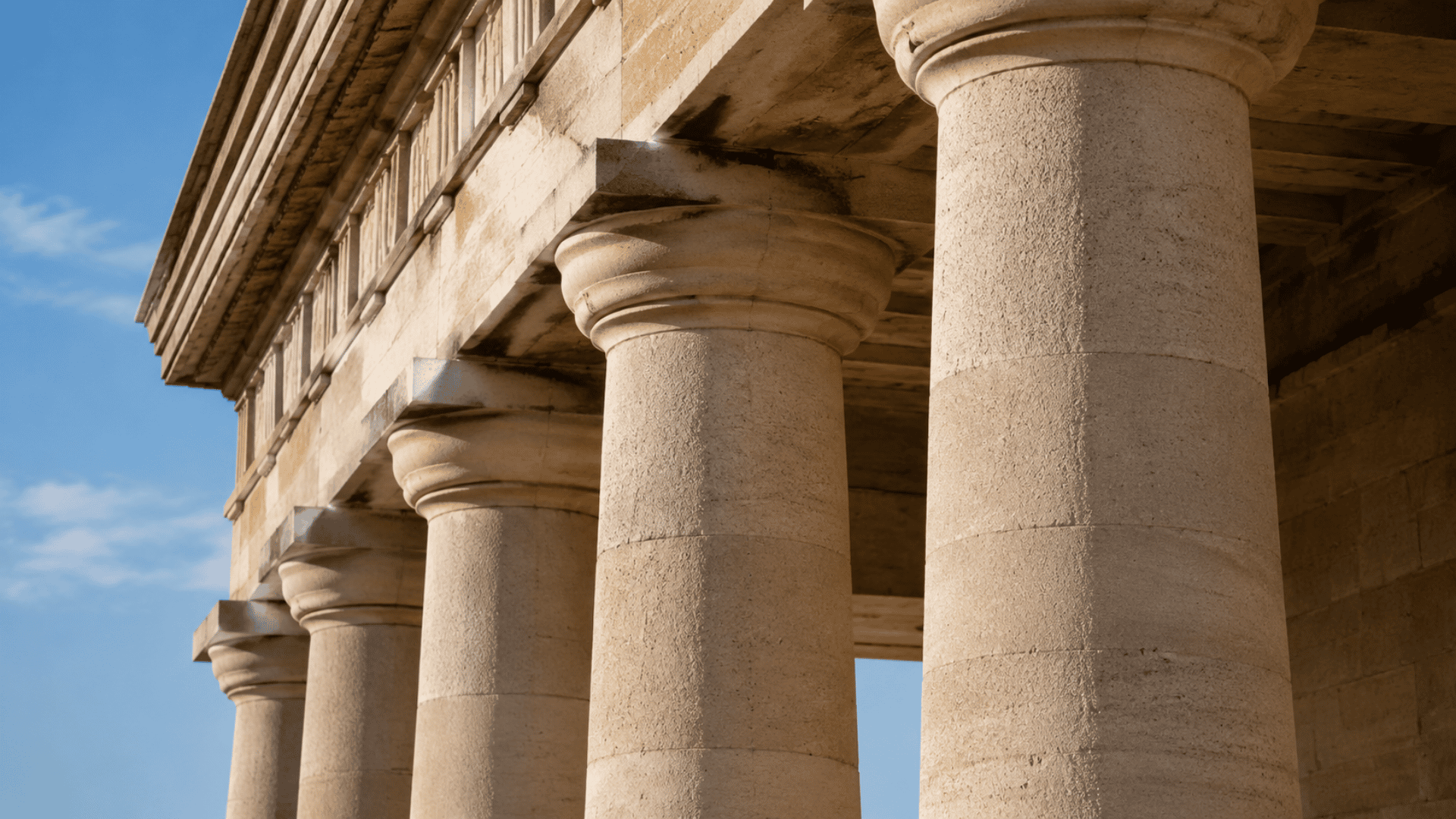 Thick sturdy Doric column with plain capital on a classical Greek building facade