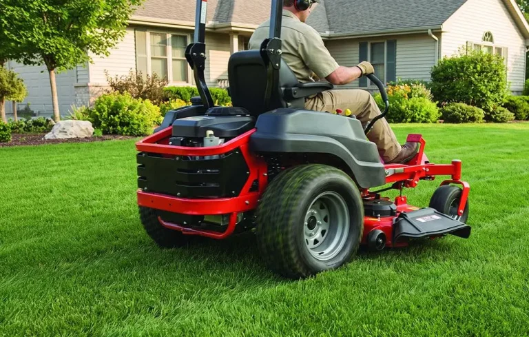 Riding lawn mower in action on lush green lawn near suburban house