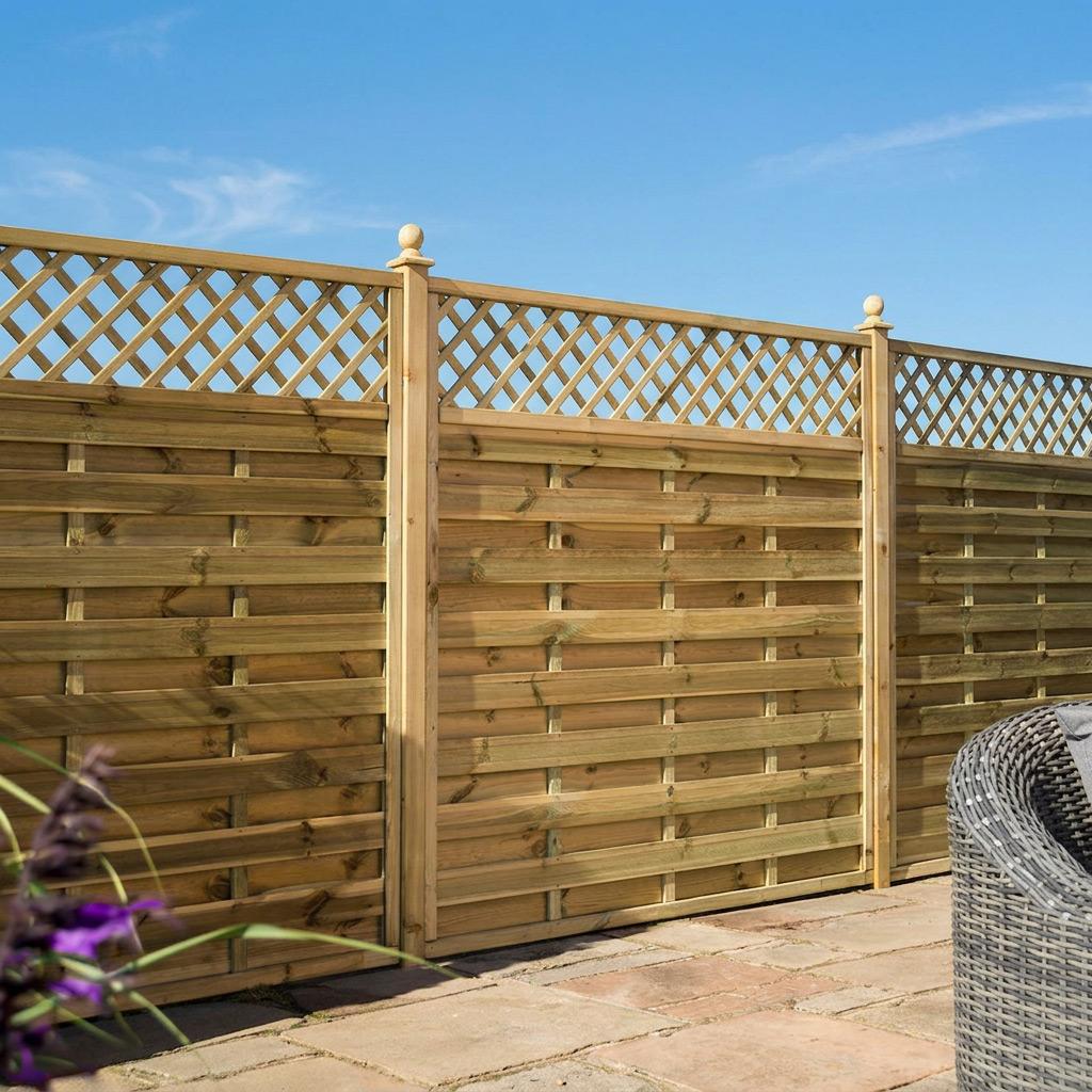 Wooden garden fence with lattice top on stone patio under clear blue sky