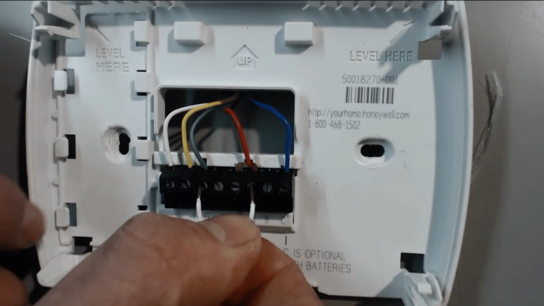 jumper wire touching thermostat R and G terminals to test whether the HVAC blower fan responds