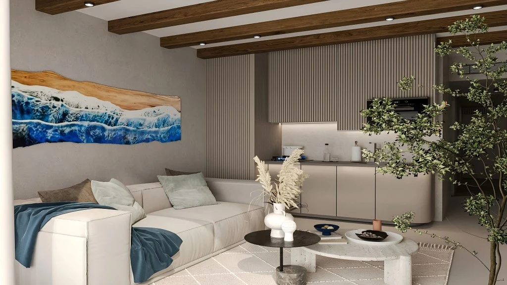 Modern living room with white sectional sofa, abstract ocean artwork, and minimalist kitchen cabinets