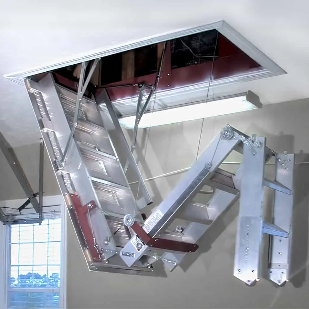 Aluminum attic ladder unfolding from ceiling in a residential interior space